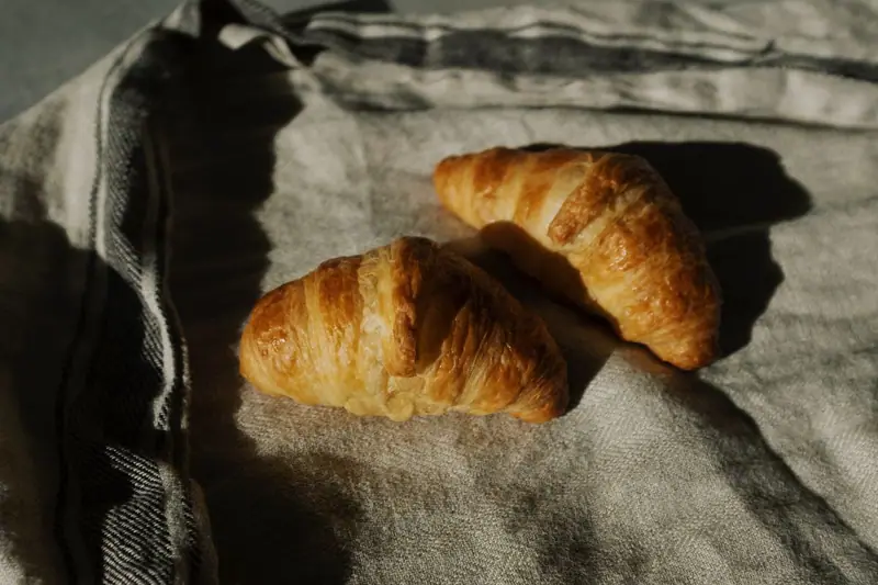 Two croissants on a linen cloth