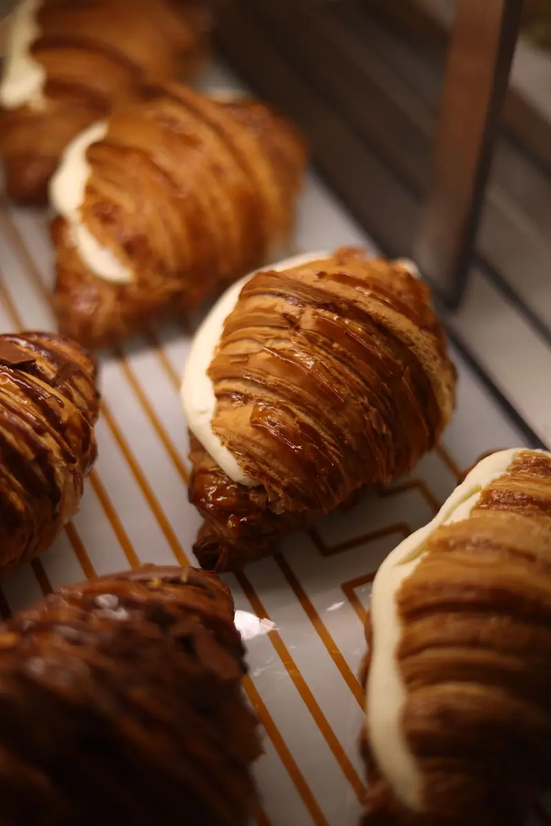 Croissants displayed on bakery trays